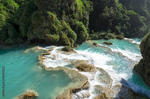 Downstream of a river with turquoise water between rocky shores