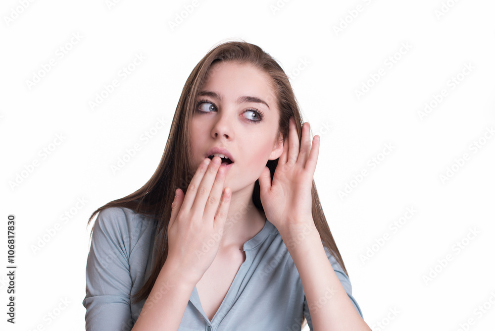 Concerned young girl with hand to ear gesture Concerned young girl with hand to ear gesture