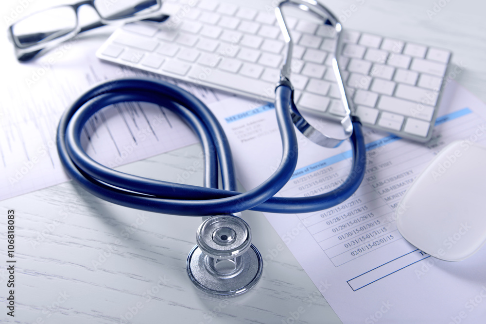 Cardiogram chart with medical stethoscope on table closeup Cardiogram chart with medical stethoscope on table closeup