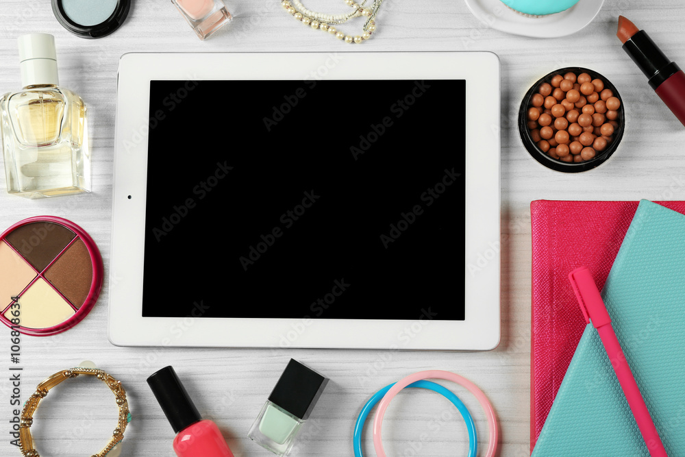 Digital tablet with woman's accessories on white wooden table background, top view Digital tablet with woman's accessories on white wooden table background, top view
