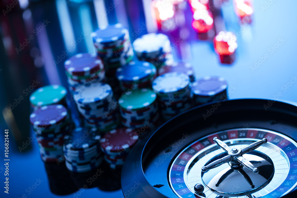 Fototapeta premium casino theme, high contrast image of casino roulette, playing chips and dice