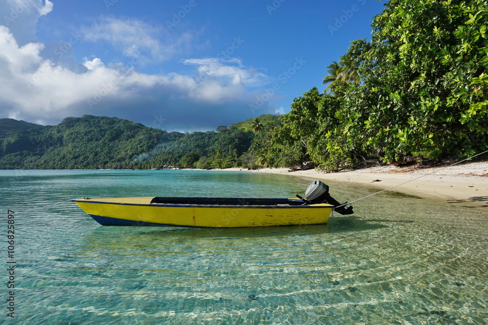 Fototapeta premium Small motor boat moored on sandy shore with tropical vegetation, Avea bay, Huahine Iti island, Pacific ocean, French Polynesia