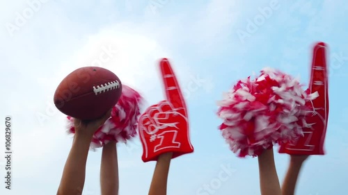 Tailgate: Football And Poms Held Up Against Blue Sky