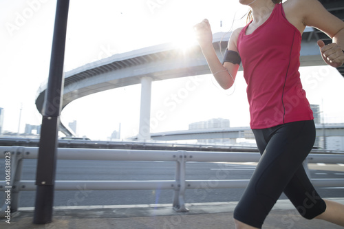 Women are jogging under the highway