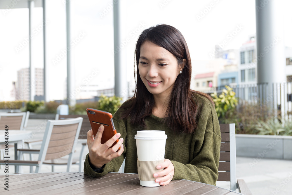 Woman use of mobile phone in coffee shop Woman use of mobile phone in coffee shop