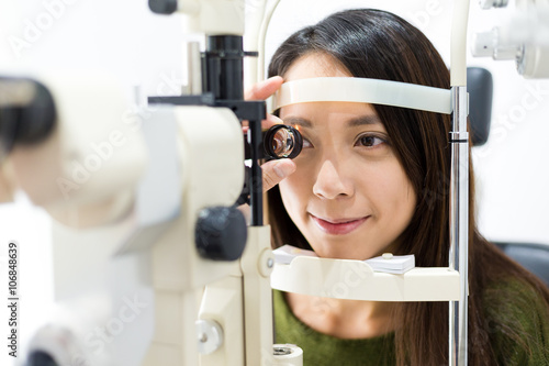 Woman cheking eye test in clinic