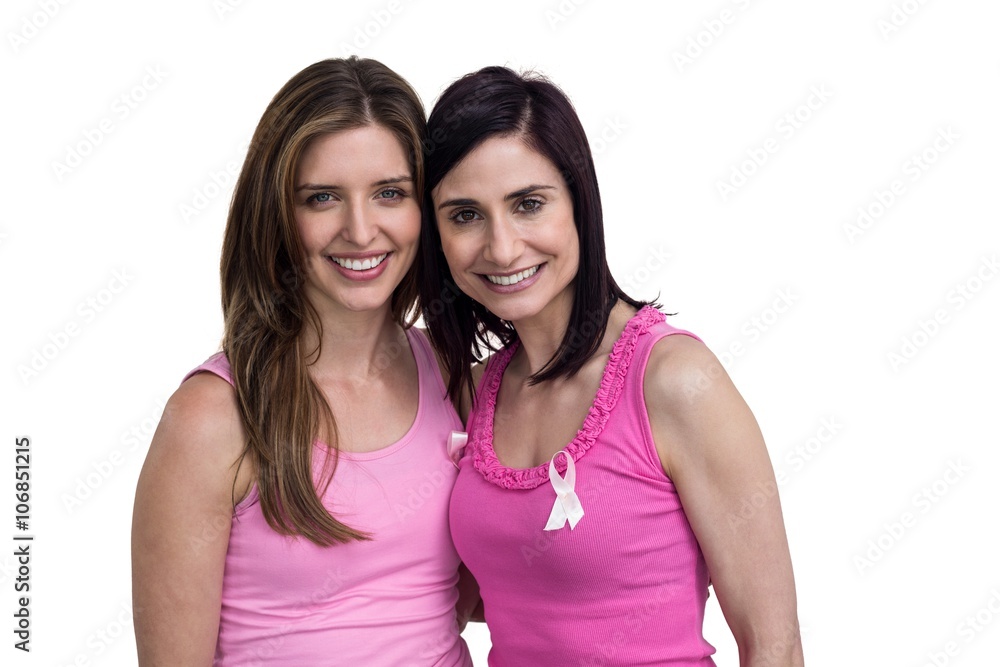 Smiling women in pink outfits posing for breast cancer awareness Smiling women in pink outfits posing for breast cancer awareness