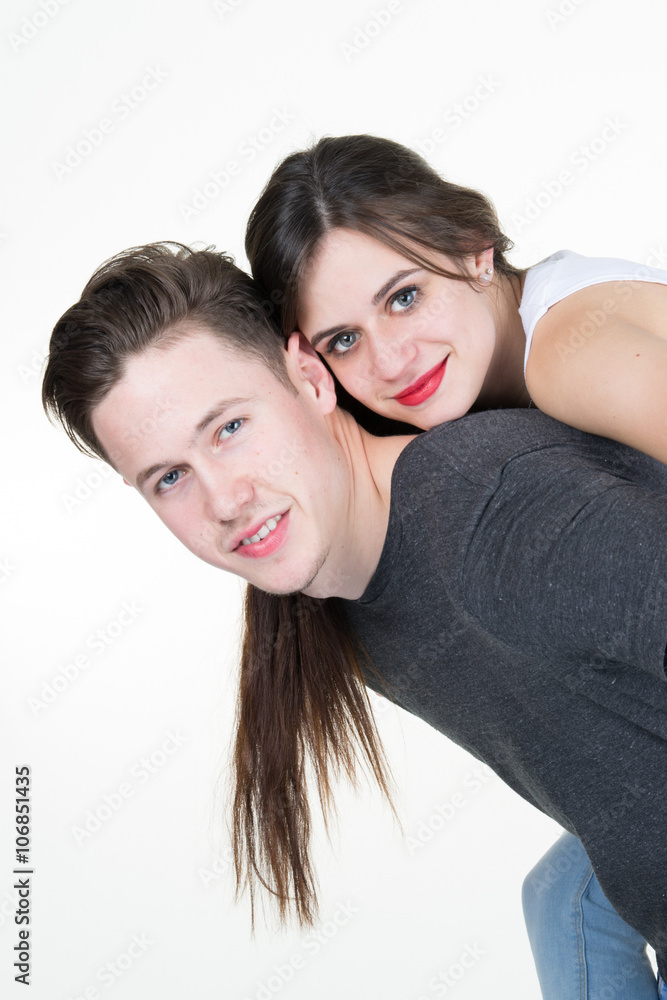 Young happy latin couple playing together piggyback isolated Young happy latin couple playing together piggyback isolated