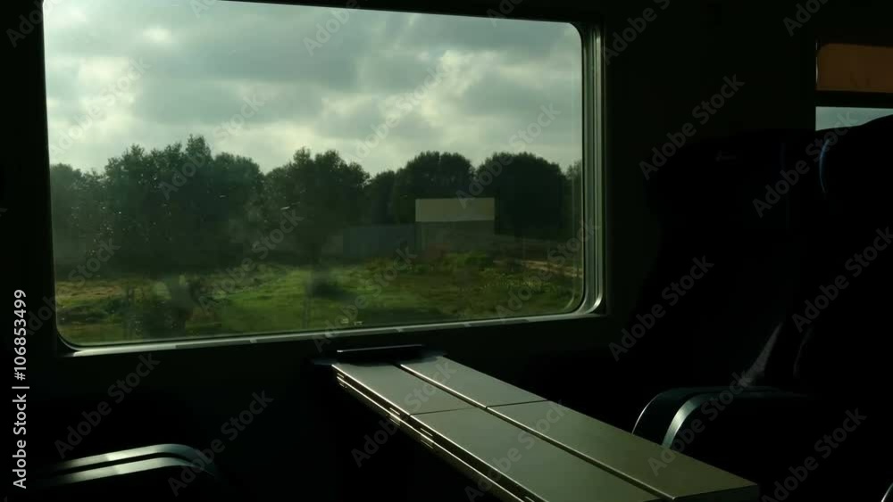 Empty seats and window on train going fast in the Italian countryside
Empty seats and window on train going fast in the Italian countryside
