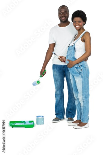 Pregnant couple with blue paint tin