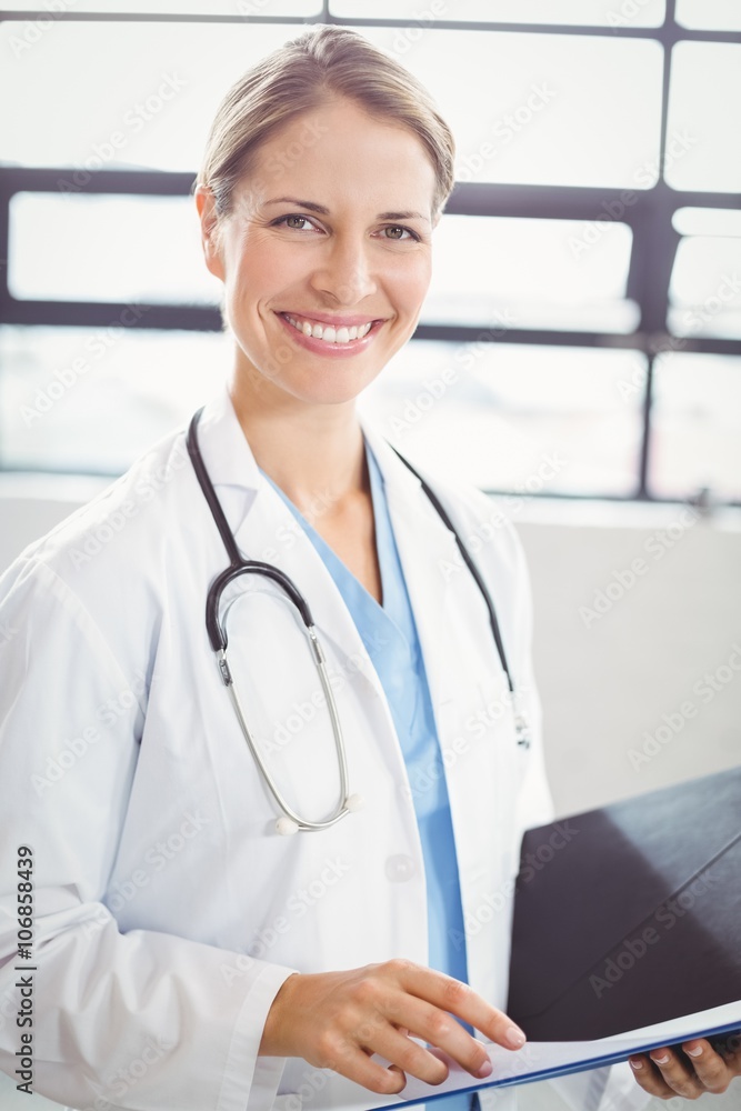 Portrait of female doctor holding medical report Portrait of female doctor holding medical report