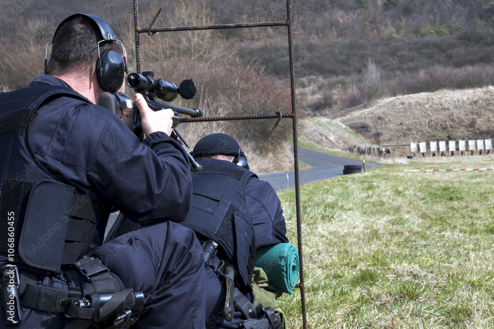 Fototapeta premium Military sniper aims at a target