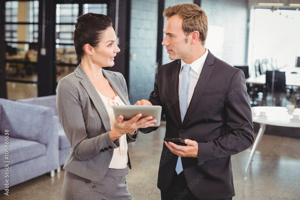 Businessman and businesswoman using digital tablet Businessman and businesswoman using digital tablet