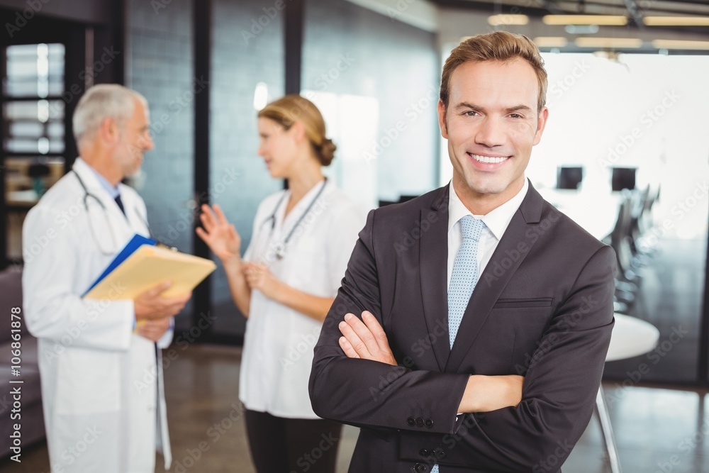 Portrait of happy doctor standing with arms crossed Portrait of happy doctor standing with arms crossed
