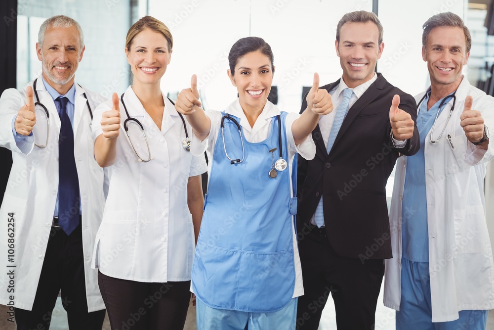 Medical team putting their thumbs up and smiling Medical team putting their thumbs up and smiling