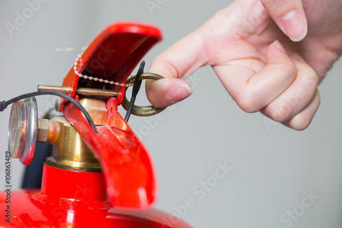 Obraz na plátne Close- up Fire extinguisher and pulling pin on red tank.