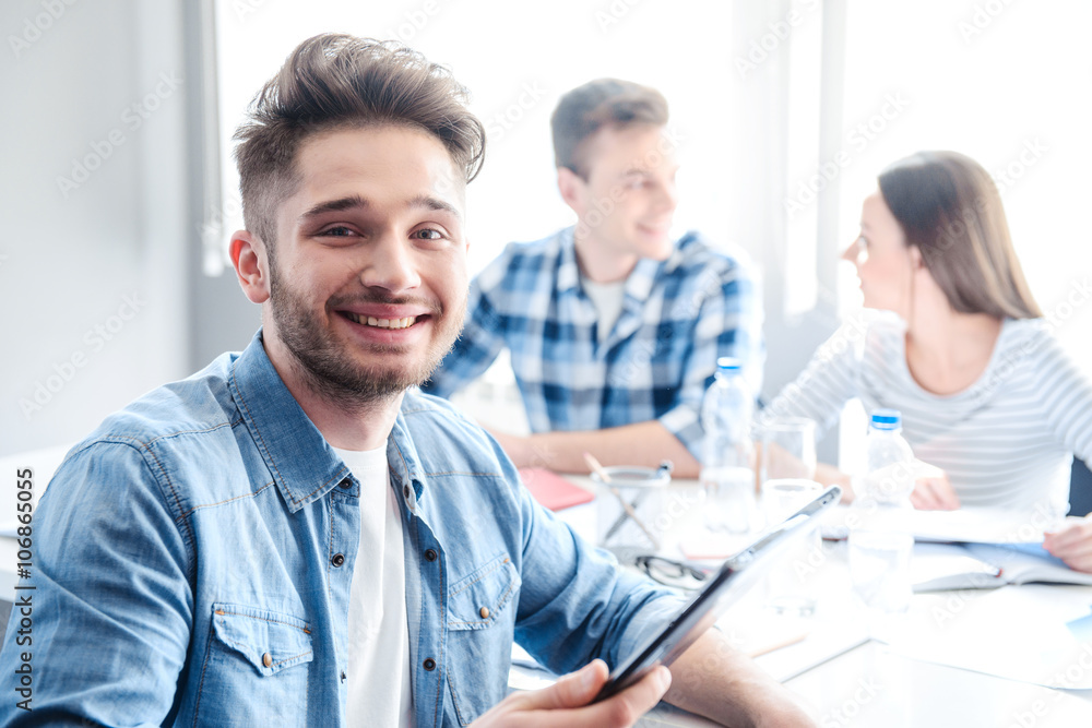 Cheerful man holding tablet Cheerful man holding tablet
