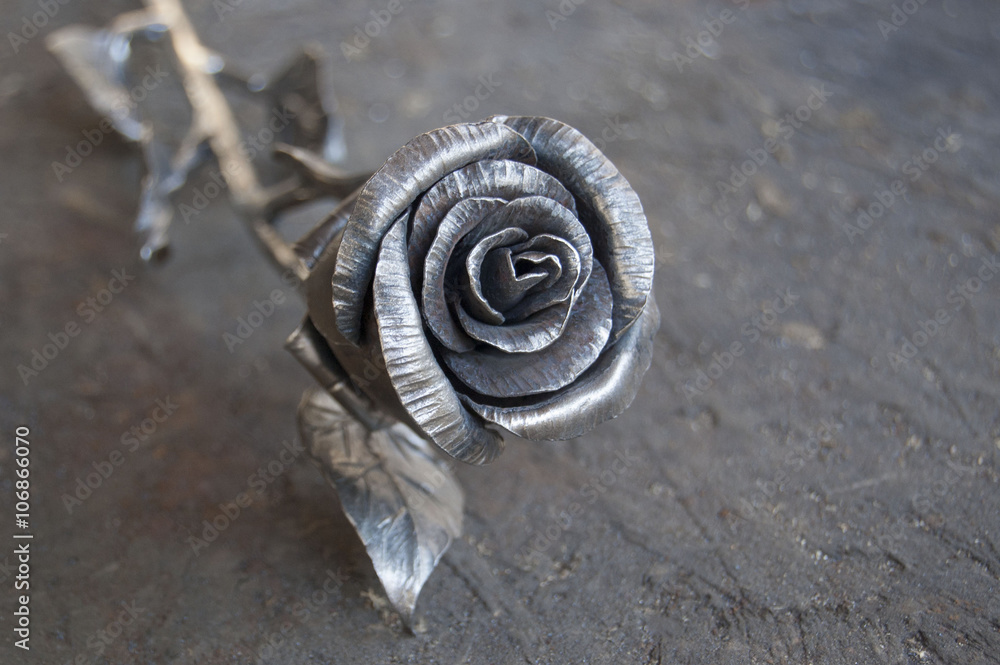 Fototapeta premium metal rose on shabby wooden background
