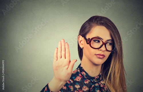 annoyed angry woman with bad attitude giving talk to hand gesture photo