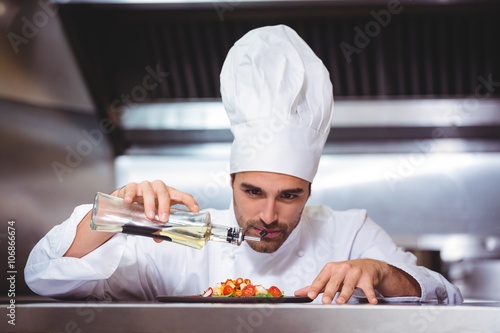 Chef putting finishing touch on salad photo