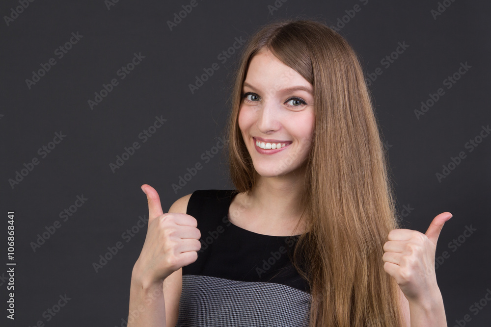 beautiful smiling girl holding thumbs up beautiful smiling girl holding thumbs up