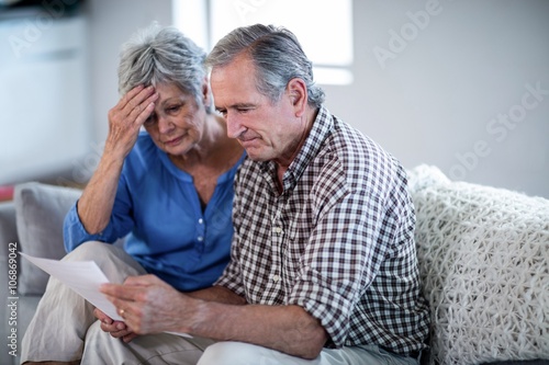Worried senior couple checking the bills