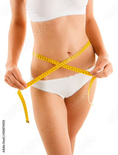 Woman measuring her slim body isolated on white background 