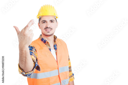 Young handsome constructor or engineer holding crossed fingers a
