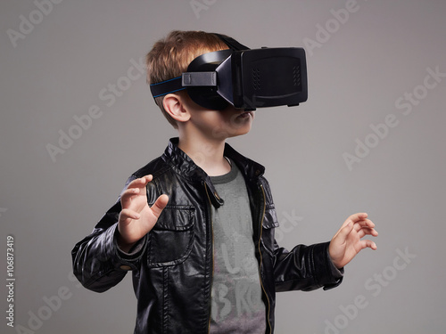 little Boy in virtual reality glasses playing the game. kids fun