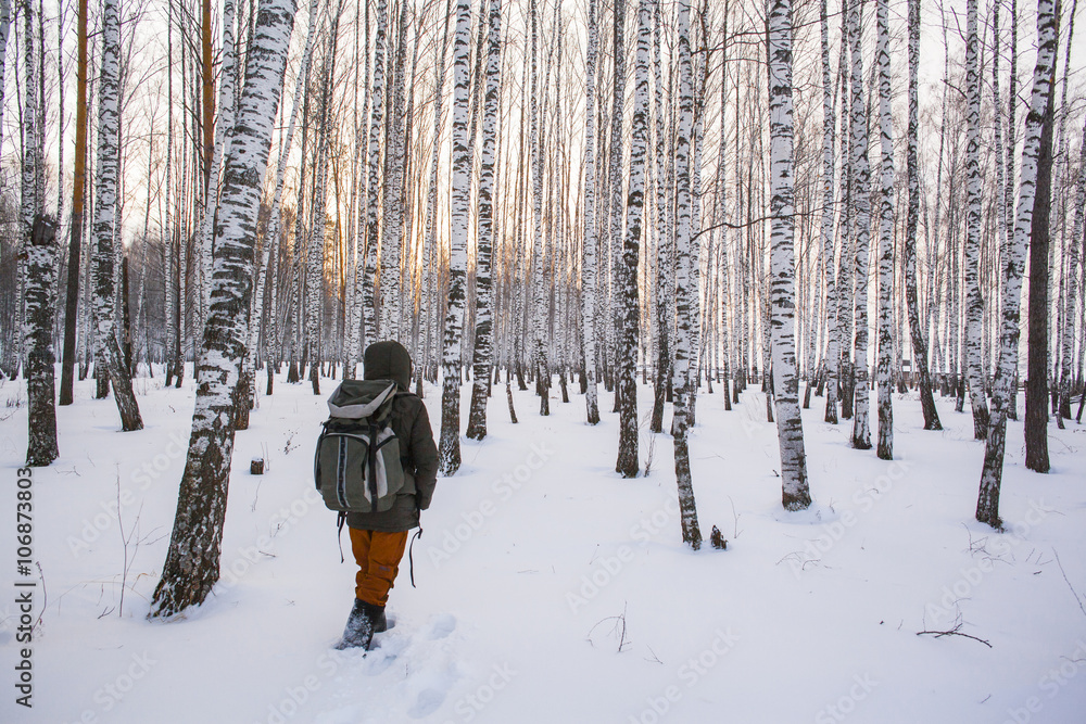 Mixed race man walking in snowy forest Mixed race man walking in snowy forest
