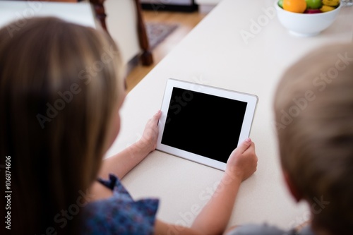Siblings using digital tablet
