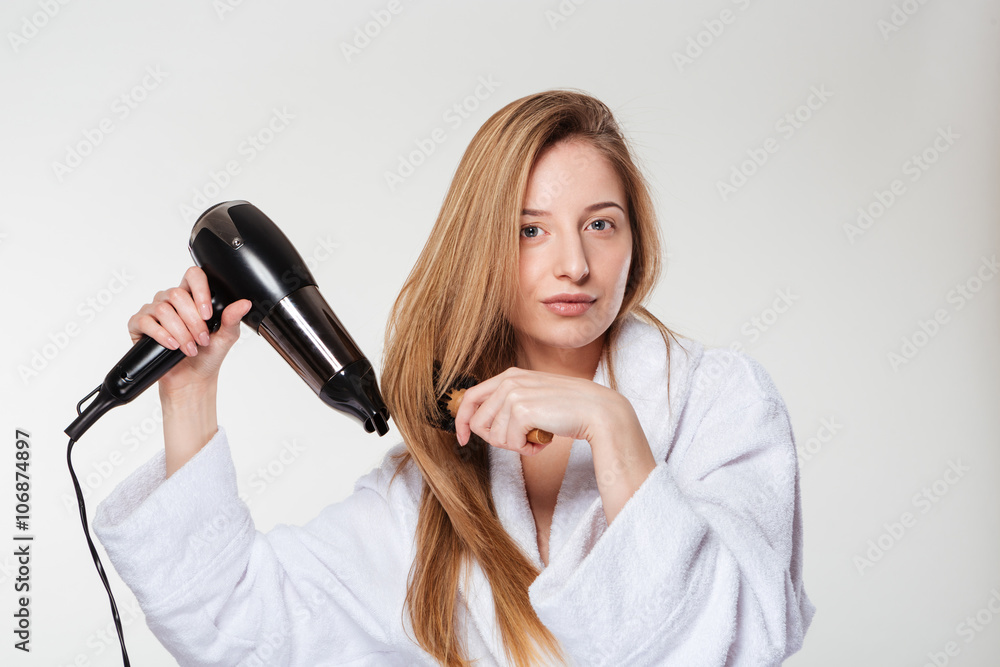Attractive woman drying her hair Attractive woman drying her hair