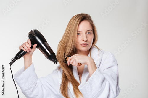 Attractive woman drying her hair