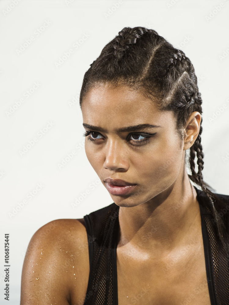 Close up of mixed race woman with braided hair Close up of mixed race woman with braided hair