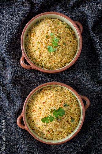 Couscous with vegetables on tablecloth 