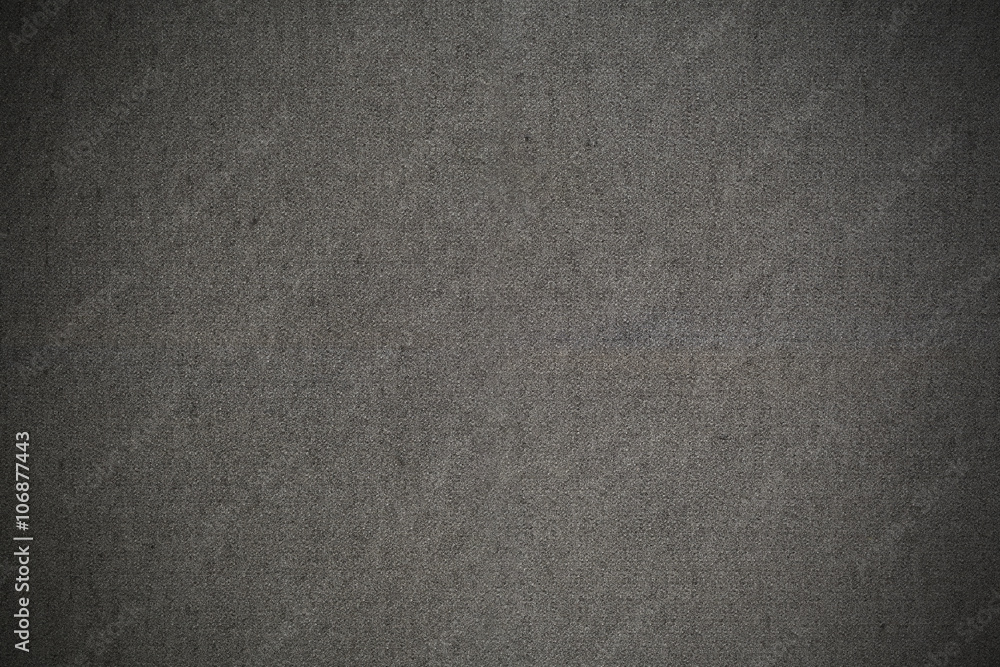 Grey textured fabric with black vignette background Grey textured fabric with black vignette background