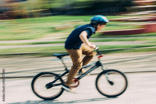 Boy riding a bike in a park