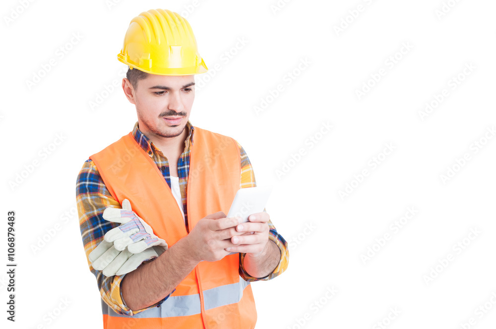Handsome engineer typing something on his white smartphone Handsome engineer typing something on his white smartphone