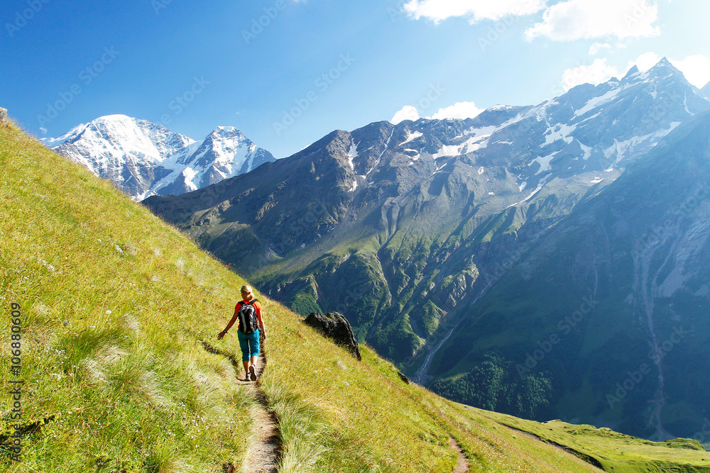The girl goes on a mountain track The girl goes on a mountain track