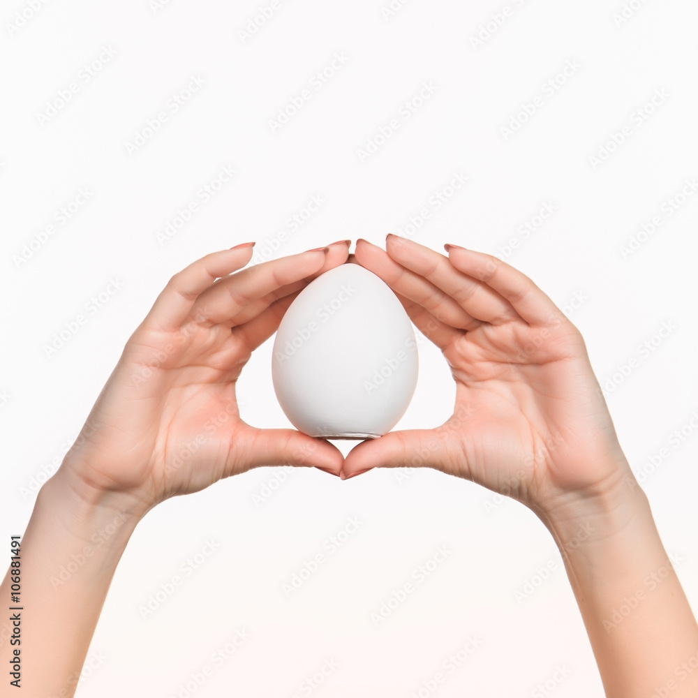 The female hand holding white blank styrofoam oval The female hand holding white blank styrofoam oval