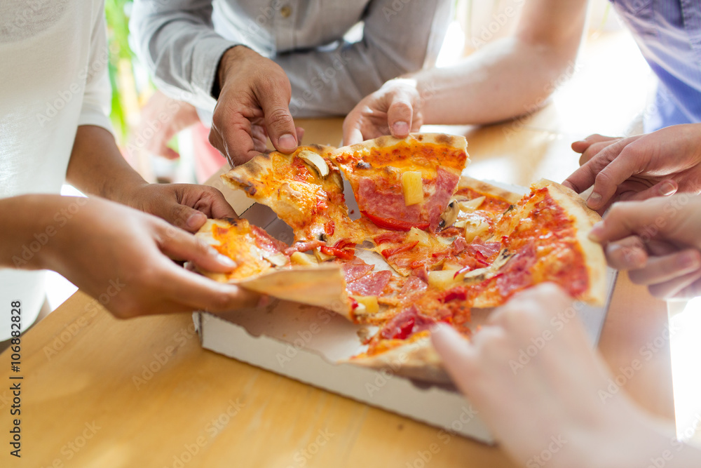 close up of friends or people eating pizza