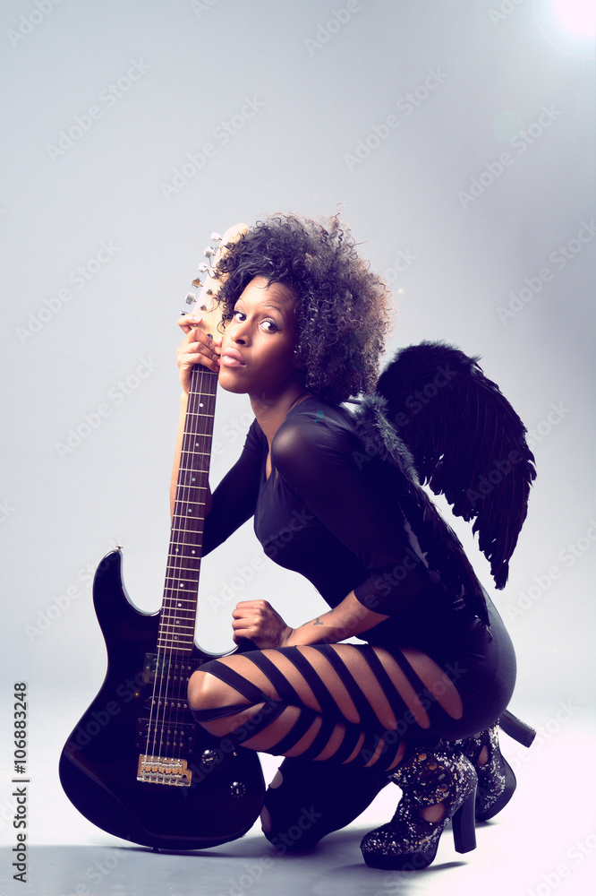 Fototapeta premium black girl, black angel with electric guitar