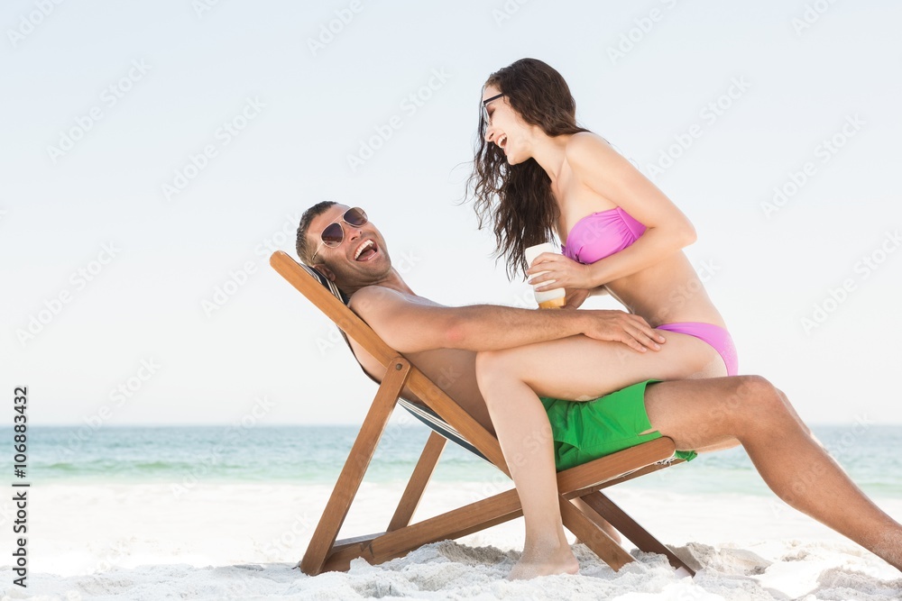 Girlfriend applying sun cream on boyfriend