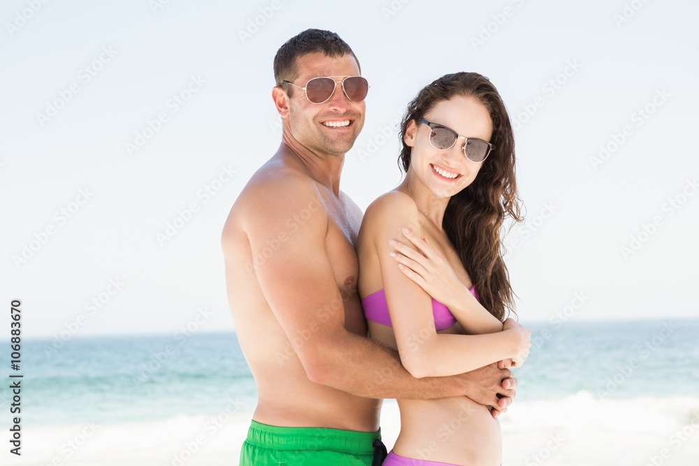 Smiling couple hugging on the beach Smiling couple hugging on the beach
