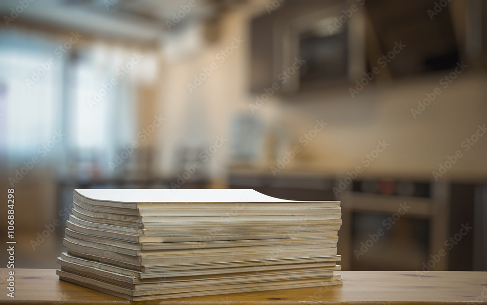 stack of old magazines on wooden table stack of old magazines on wooden table