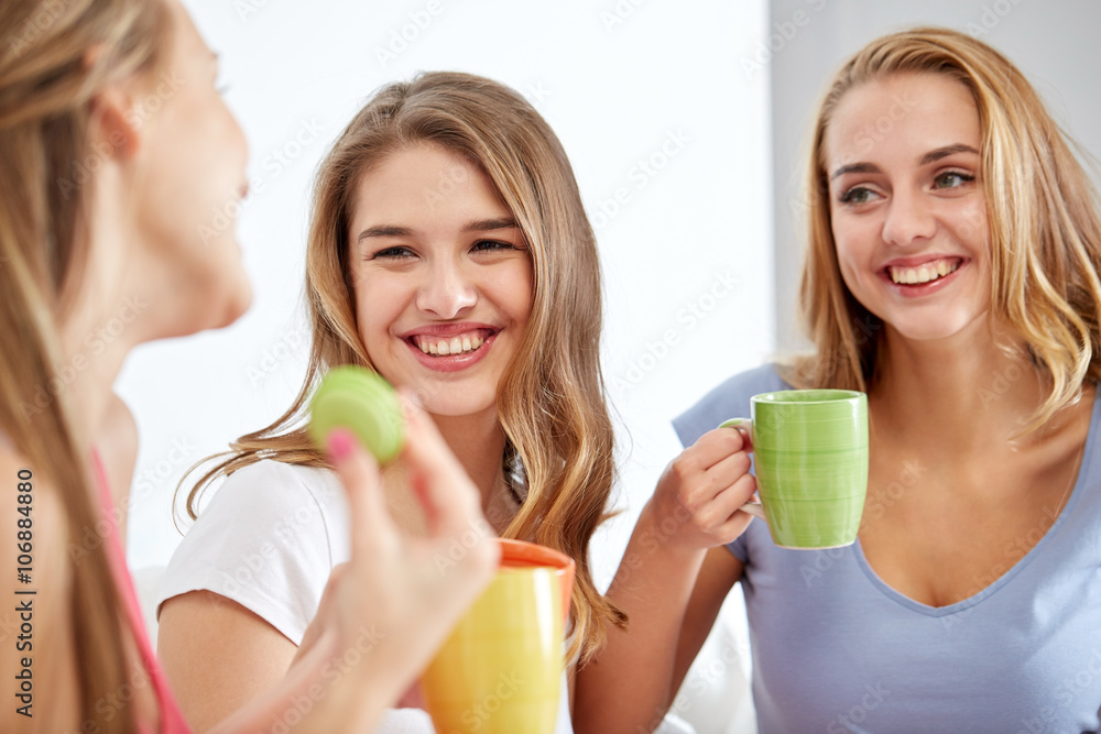 happy young women drinking tea with sweets at home happy young women drinking tea with sweets at home