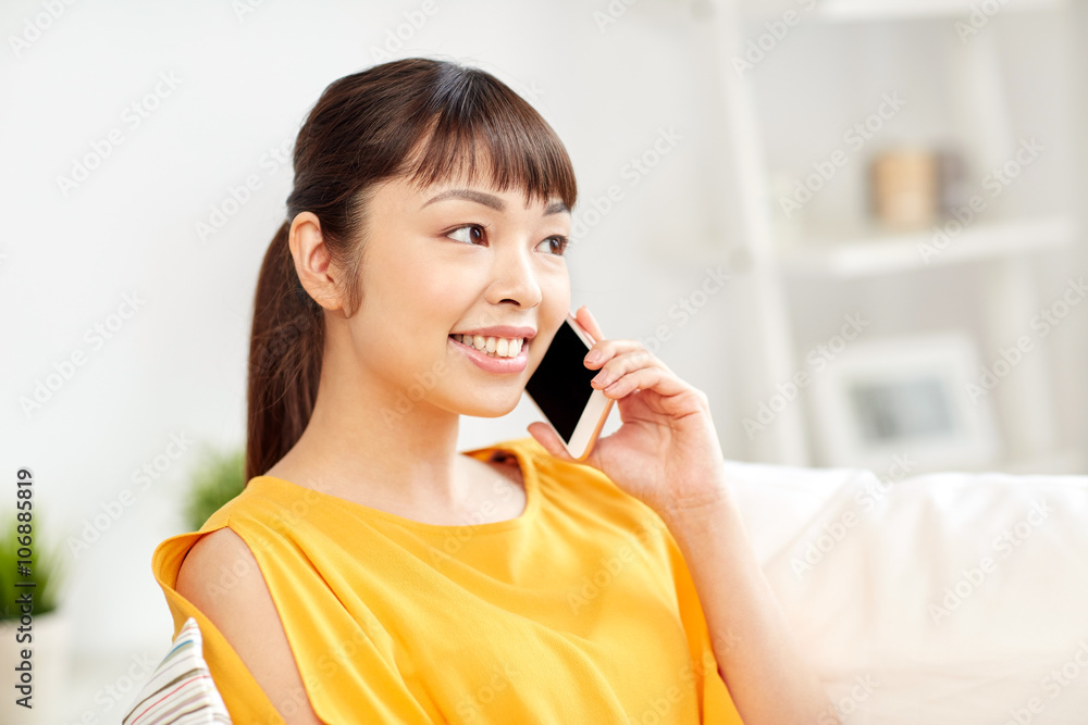happy asian woman calling on smartphone at home happy asian woman calling on smartphone at home