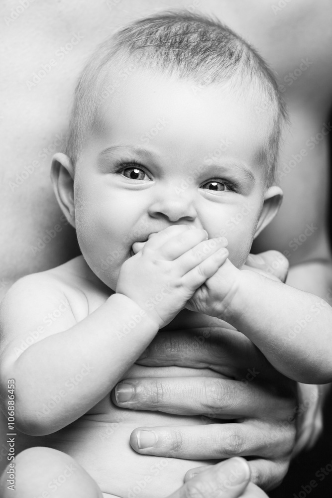 Young father is feeding his baby daughter.baby girl smiling at the hands of the father.black and white Young father is feeding his baby daughter.baby girl smiling at the hands of the father.black and white