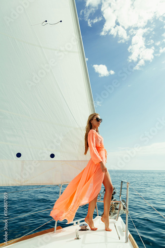 woman in sarong yachting white sails luxury travel