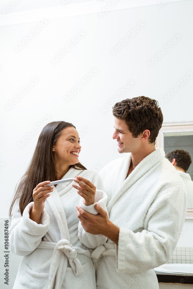 Happy couple checking pregnancy test Happy couple checking pregnancy test